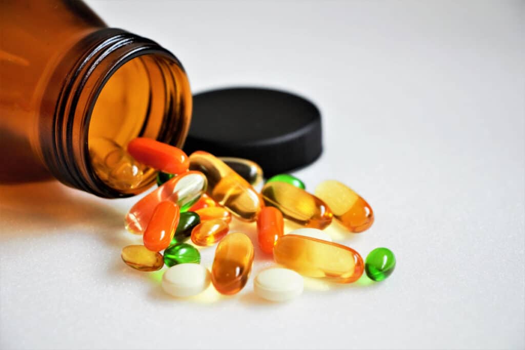 A bottle of spilled vitamins, representing the Member's Mark turmeric curcumin complex joint health supplements class action