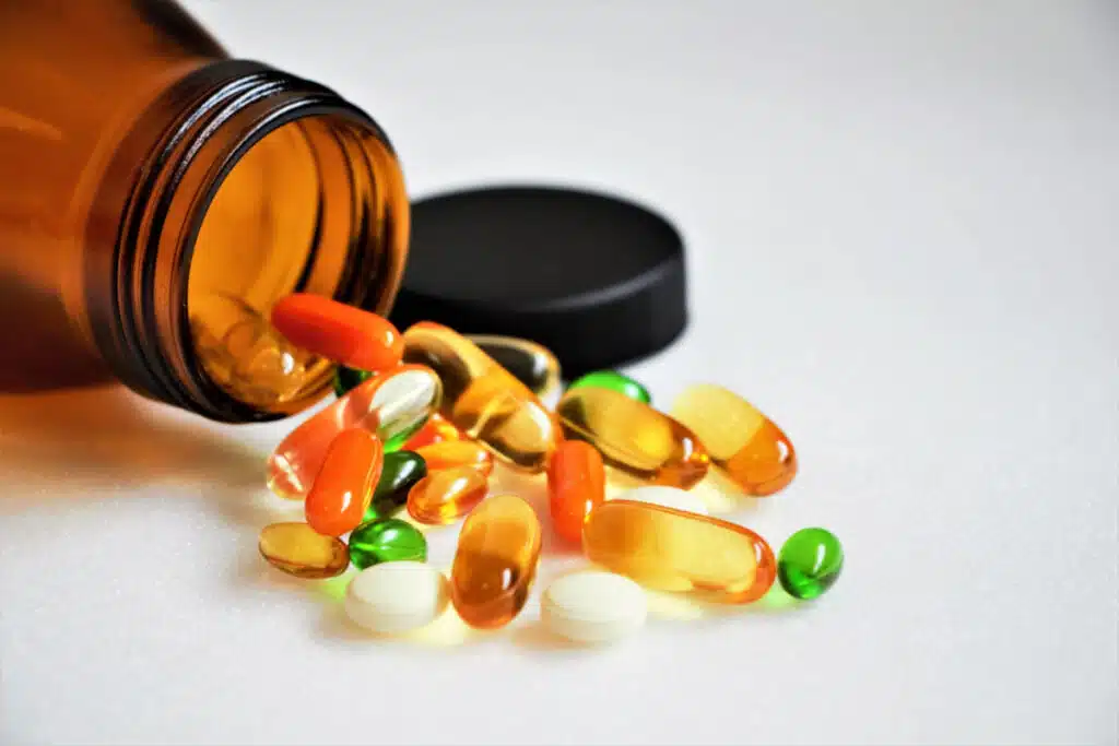 A bottle of spilled vitamins, representing the Member's Mark turmeric curcumin complex joint health supplements class action