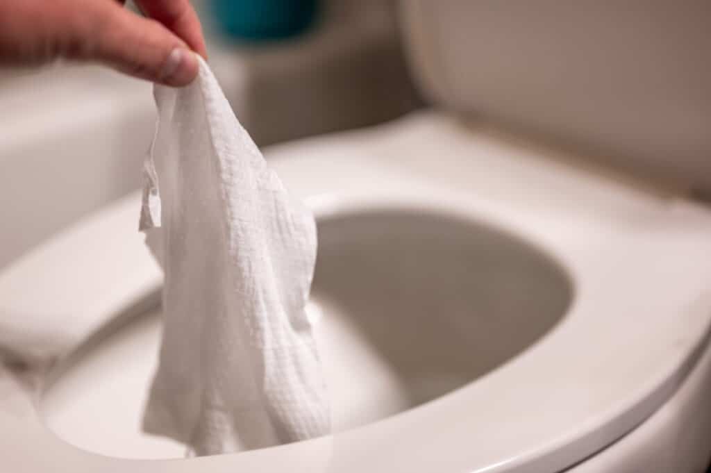 Disposable wipes being flushed down a toilet