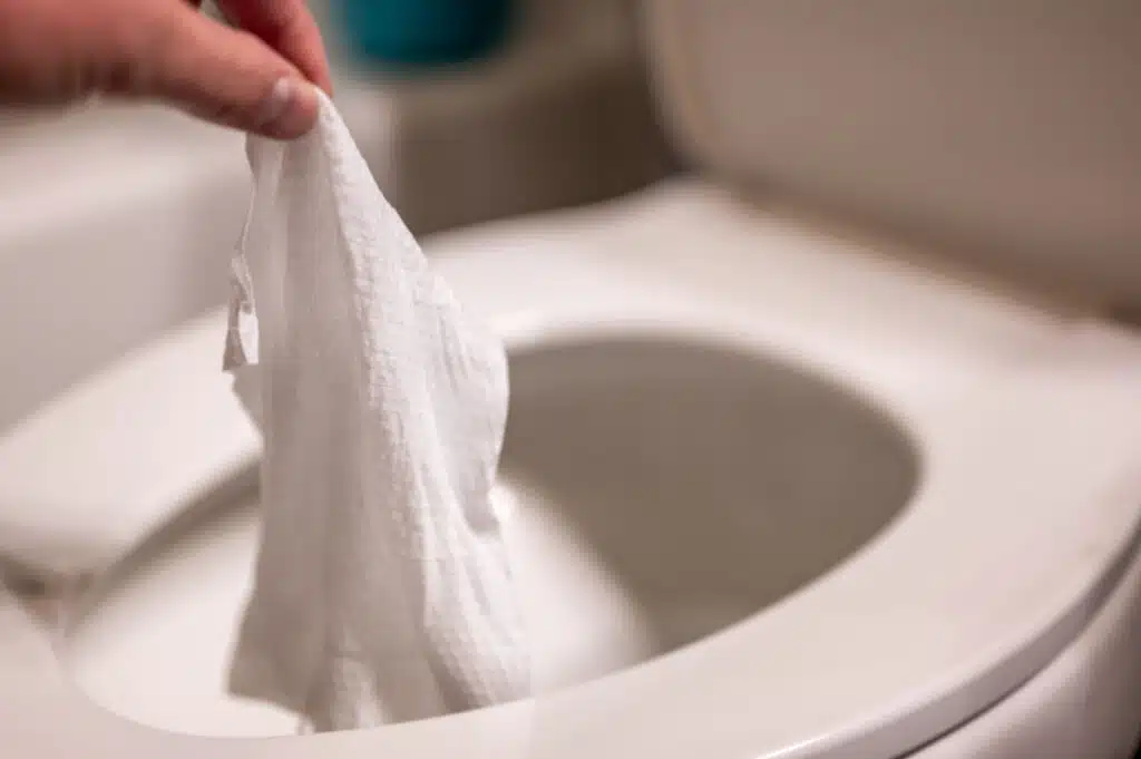 Disposable wipes being flushed down a toilet