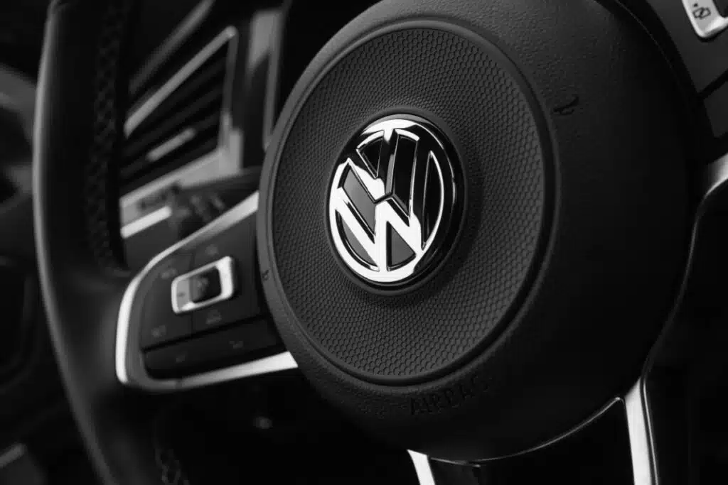 Black steering wheel with logotype of second generation Volkswagen, representing the VW sunroof settlement