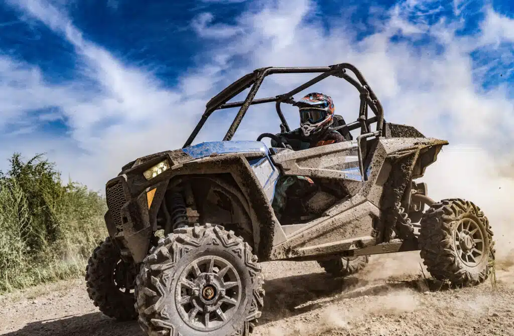 A man driving an off road buggy, representing ATV recalls.