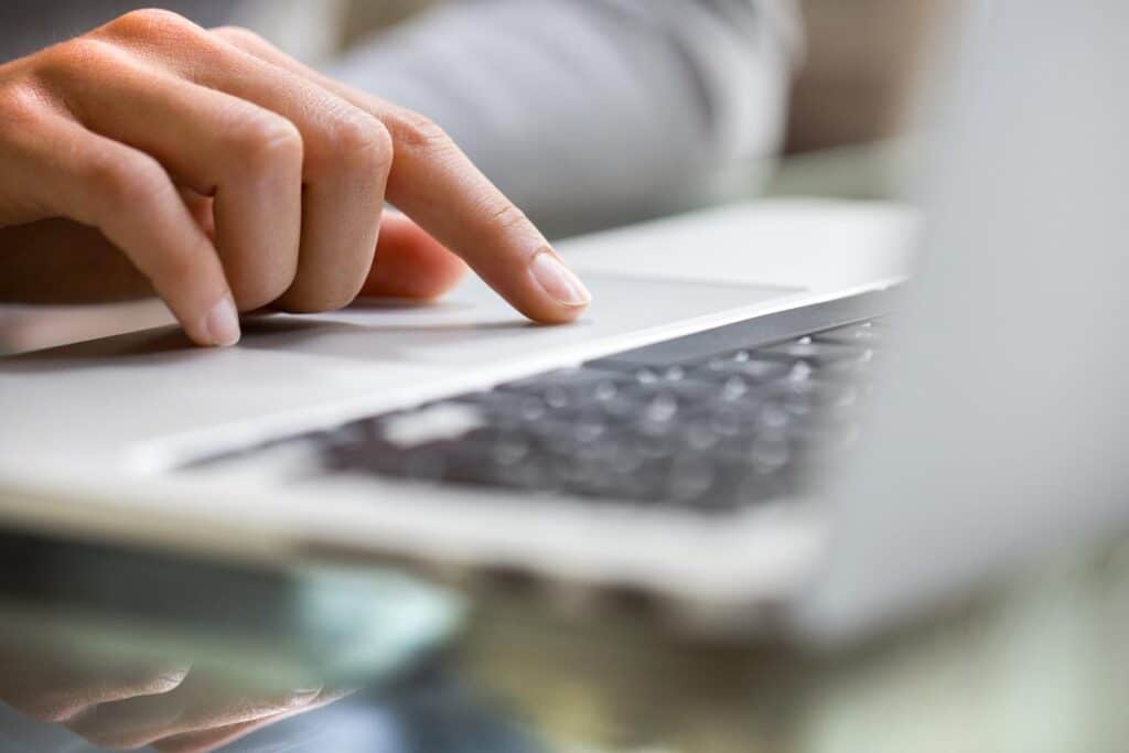 Close up of a hand using the trackpad on a laptop,