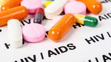 Pills on Hiv / aids paper background.