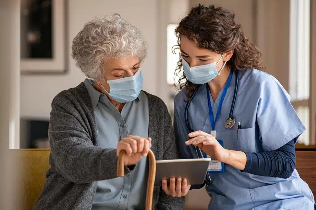 Senior lady and doctor looking at information on a tablet, representing the SuperCare Health data breach class action lawsuit settlement.