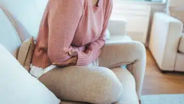 Woman holding stomach in pain