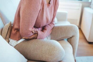 Woman holding stomach in pain