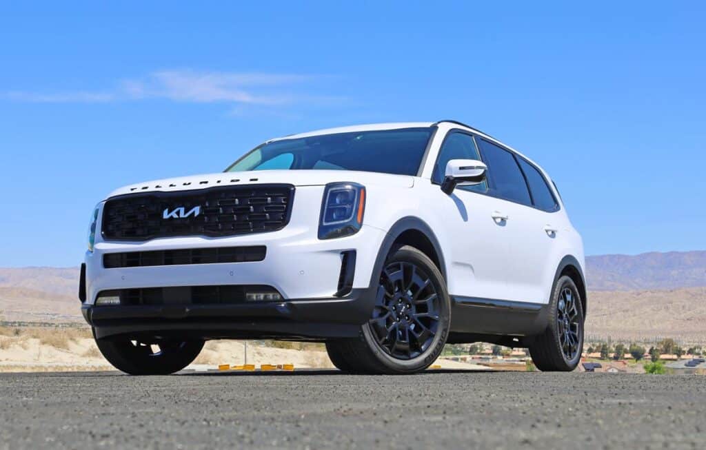 A 2022 Kia Telluride in the desert against a blue sky.