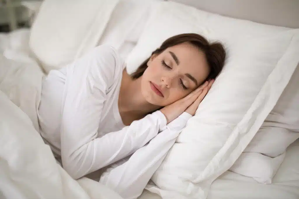 A woman sleeps peacefully in her bed, representing the Avocado class action lawsuit