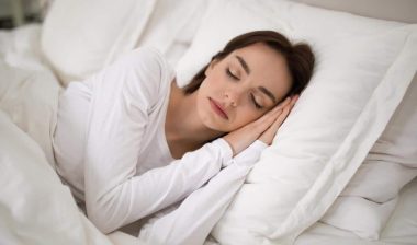 Woman sleeping peacefully in her bed.