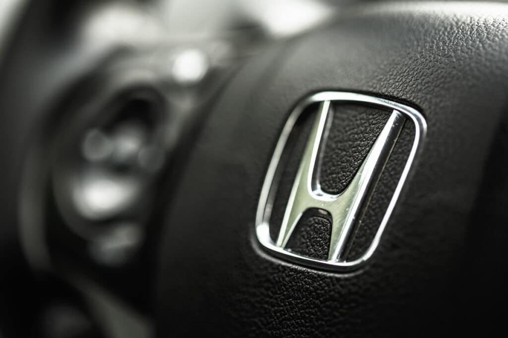 Close up of Honda emblem on a steering wheel.