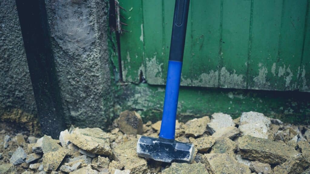 sledge hammer leaning against wall