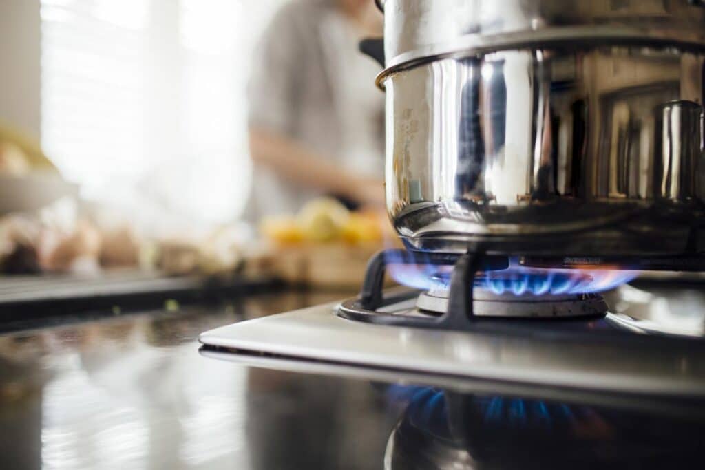 Close up of a pot on a gas stove.