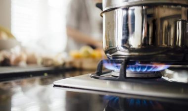 Close up of a pot on a gas stove.