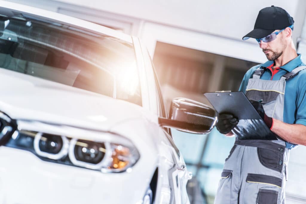 Pre Owned Vehicle Evaluation by Caucasian Car Mechanic.