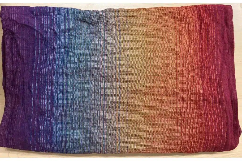 Product photo of infant sling carrier by Girasol, representing the Girasol Rainbow Love Woven Wrap warning.