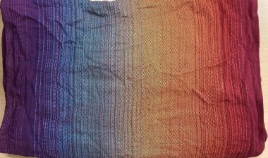 Product photo of infant sling carrier by Girasol, representing the Girasol Rainbow Love Woven Wrap warning.