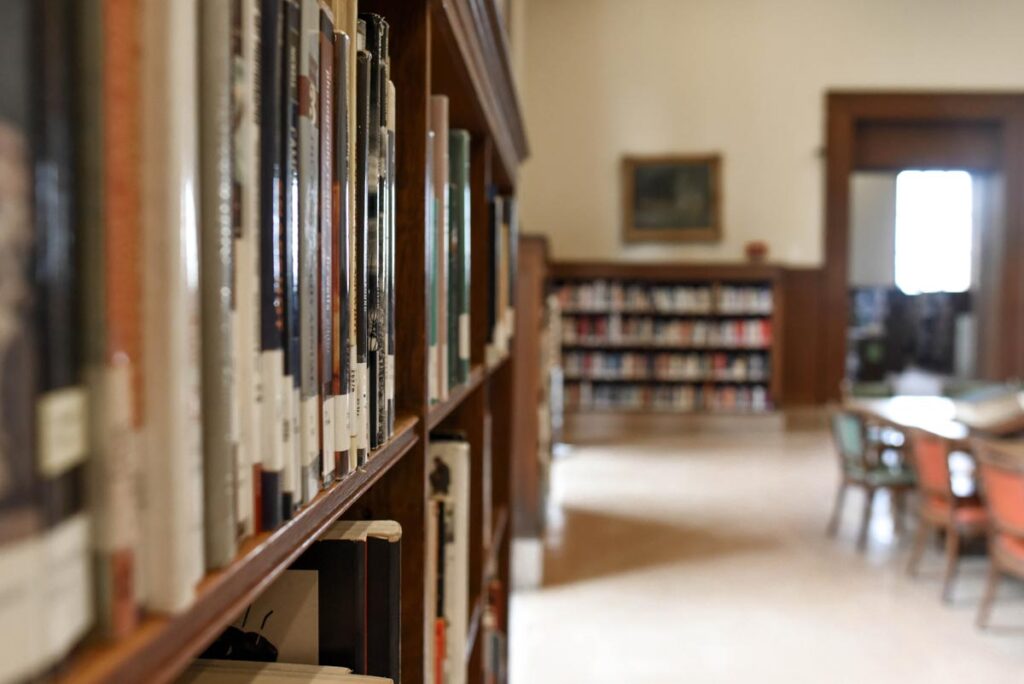 Close up of books on a bookshelf in a school library, representing the Penguin Random House book ban class action.