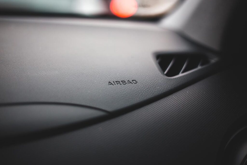 Close up of airbag text on dashboard of car, representing auto recalls.