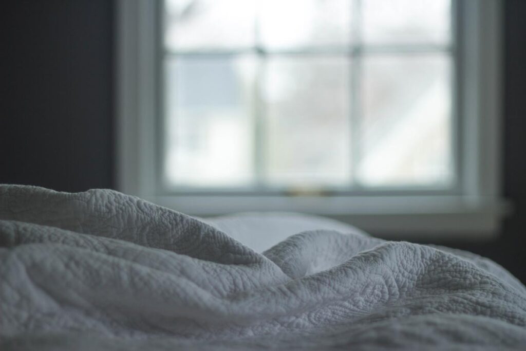 White linen bedding is seen, representing the Simmons and Beautyrest products class action.