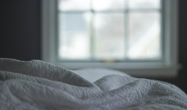 Close up of white linen bedding, representing the Simmons class action.