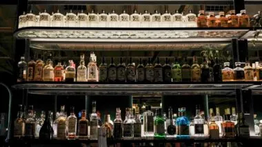 Bar shelves filled with bottles, representing the Diddy Diageo lawsuit.