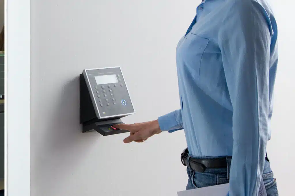 Close up of a females hands using a biometric time clock, representing the Forman Mills settlement.