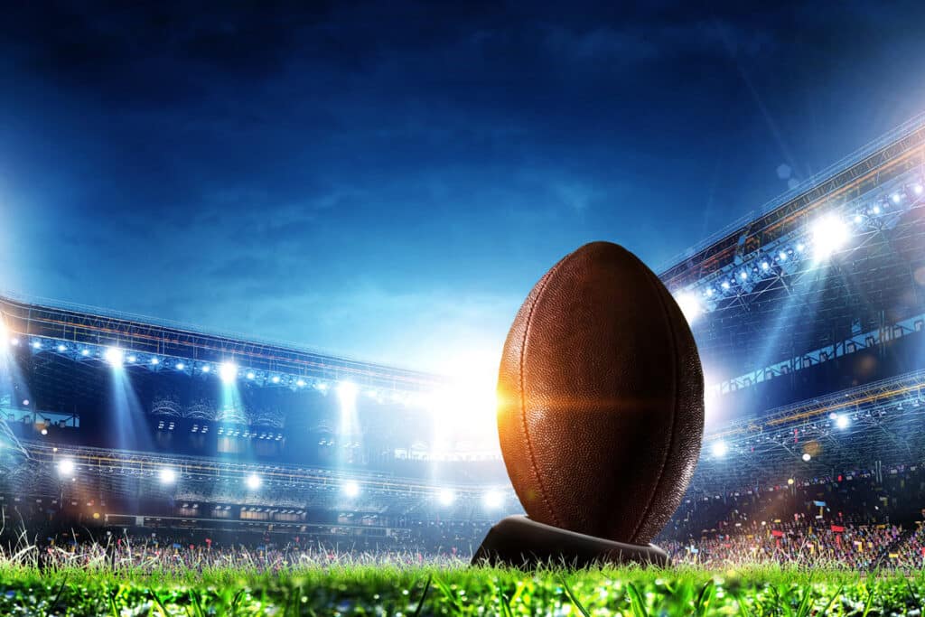 Close up of a football in a stadium, representing the NFL Hall of Fame lawsuit.