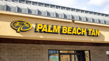 Close up of Palm Beach Tan signage on a building, representing the Palm Beach Tan text messages class action.