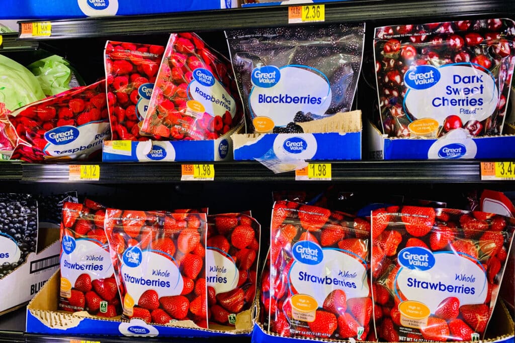 Close up of Great Value frozen fruit products in a grocery store freezer, representing the frozen fruit recall.