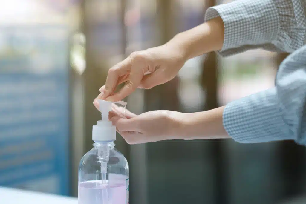 Close up of a girls hands putting hand sanitizer on, representing the Artnaturals hand sanitizer settlement.