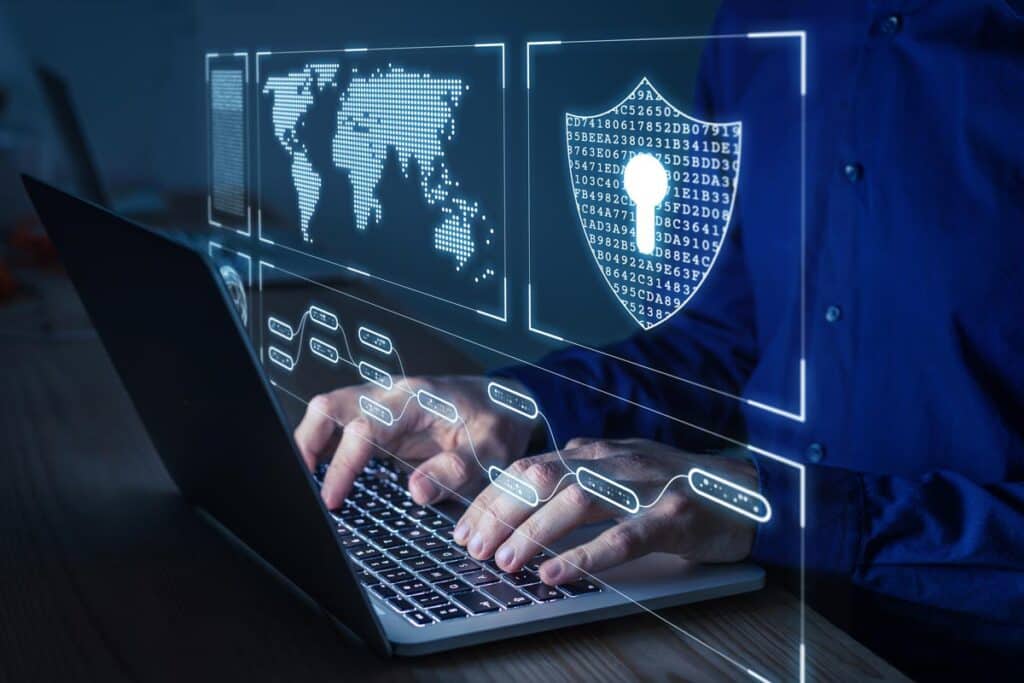 Close up of male hands typing on a keyboard with a data security concept overlay, representing the Comprehensive Health Services data breach class action lawsuit settlement.