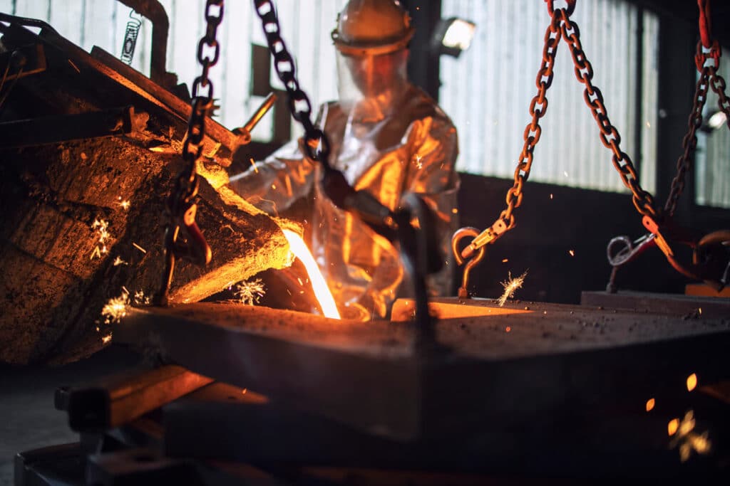 A worker pouring hot molten, representing the USMR settlement.