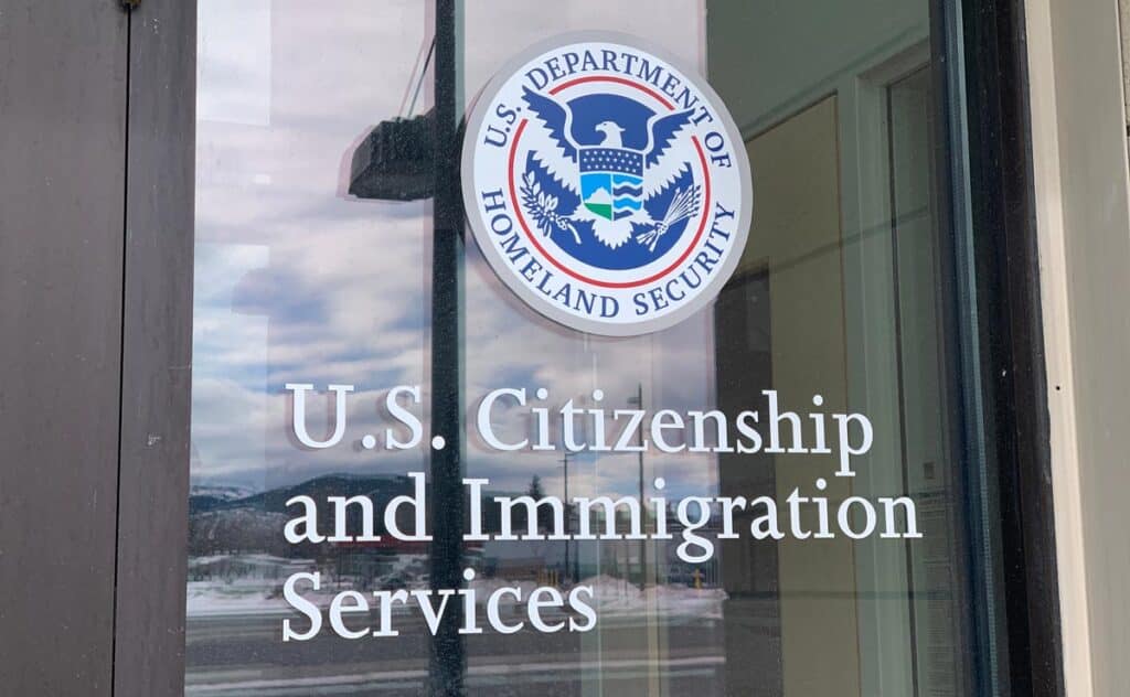 Close up of US Citizenship and Immigration services signage, representing the Ukrainian, Afghan parolees class action.