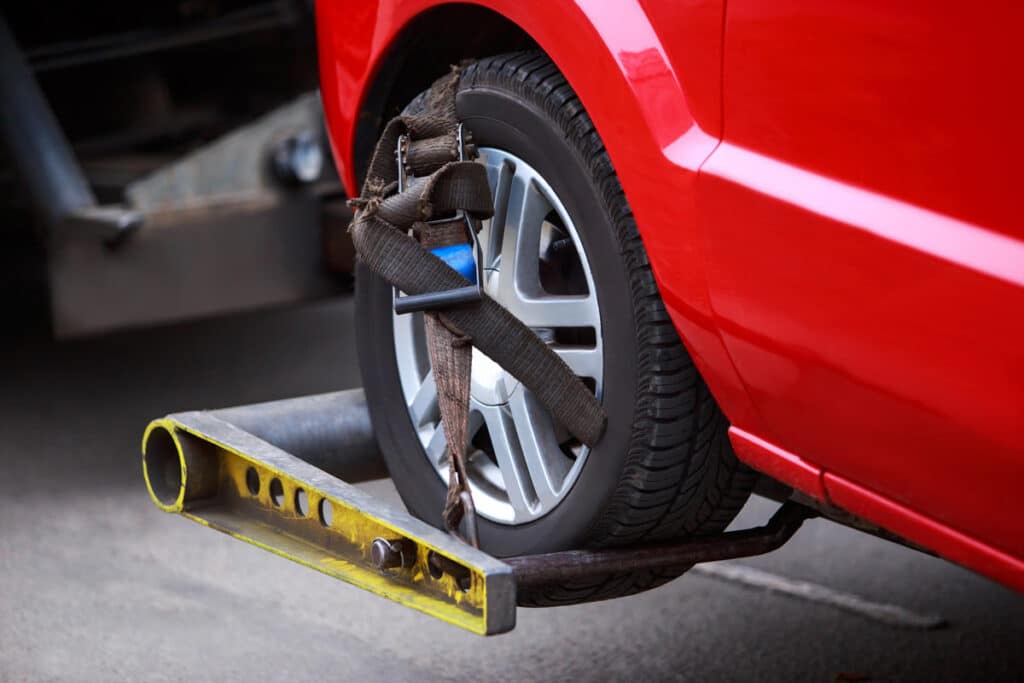 Close up of a vehicle wheel attached to a tow truck, representing the Larsen’s Automotive settlement.