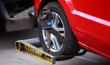 Close up of a vehicle wheel attached to a tow truck, representing the Larsen’s Automotive settlement.