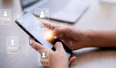 Hands using a smartphone with a recruitment overlay, representing the Tranzact settlement.