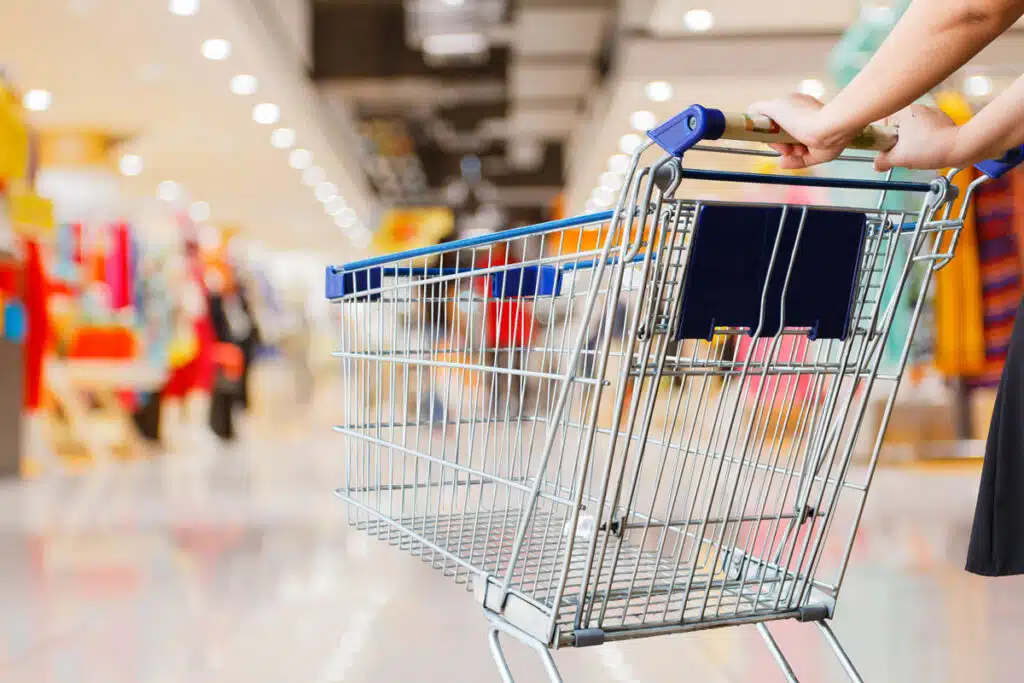 Close up of a shopping cart being pushed in a shopping mall, representing the top recalls for the week fo June 19.