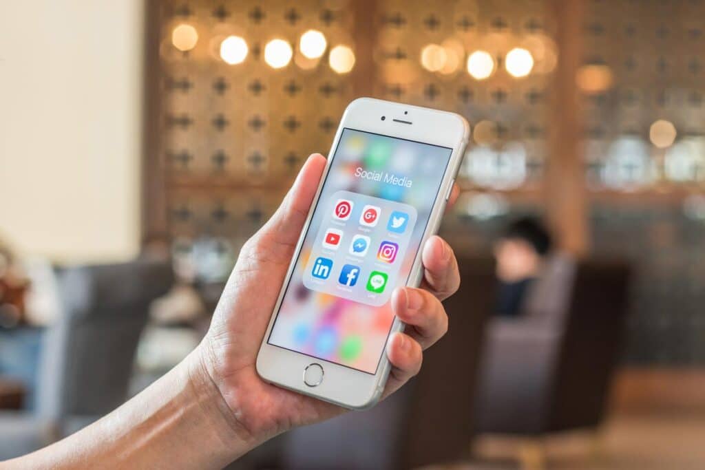 Close up of hand holding smartphone with social media app icons displayed, representing the updated Protecting Americans’ Data from Foreign Surveillance Act.