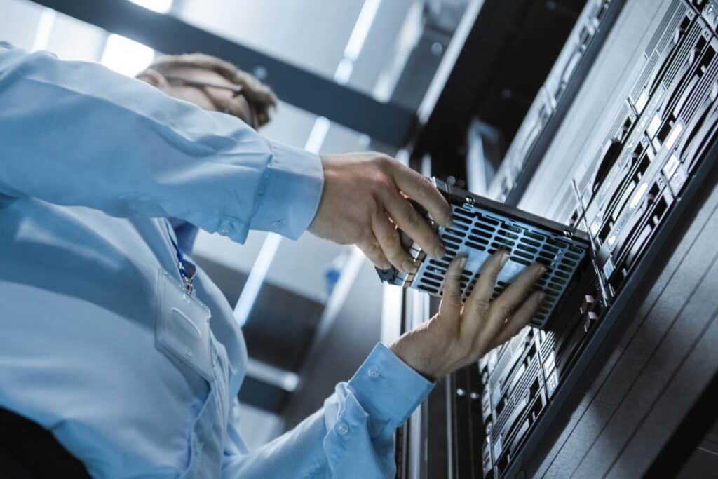 IT professional replacing a server, representing the Harvard Health Plan data breach class action.