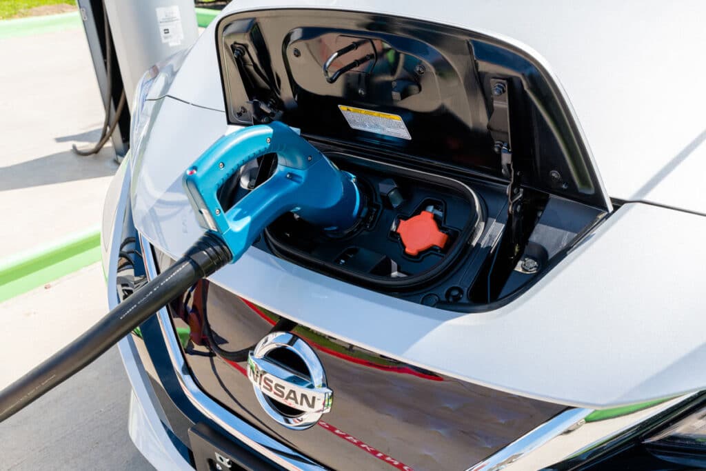 Close up of a Nissan Leaf being charged, representing the Nissan LEAF recall.