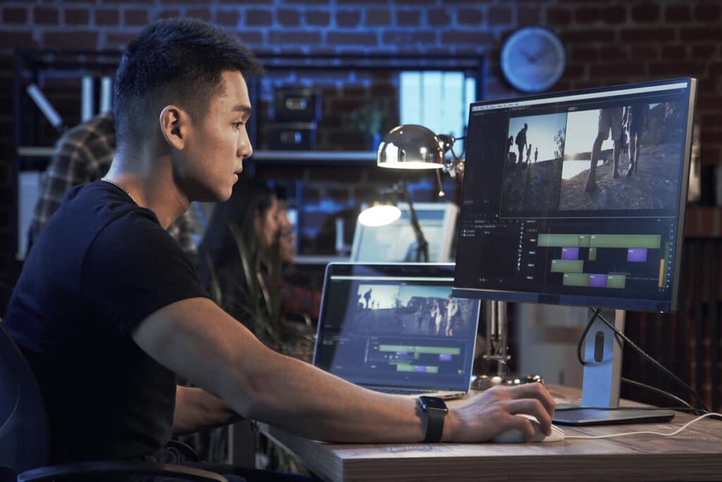 A video programmer working on a computer, representing FCC video rule making.