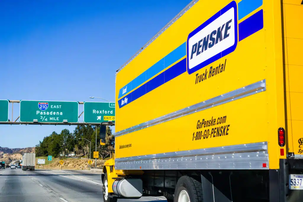 A Penske rental truck driving on the freeway, representing the Penske class action.