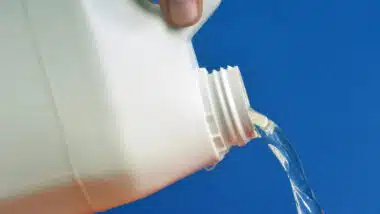 Close up of bleach being poured, representing the fake COVID cure.