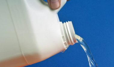 Close up of bleach being poured, representing the fake COVID cure.