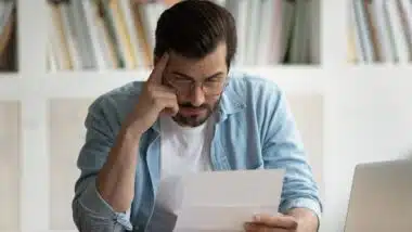Man reading Data breach notification, Data breach letters inform consumers when and how their information was compromised by data breach incidents.