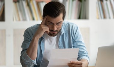 Man reading Data breach notification, Data breach letters inform consumers when and how their information was compromised by data breach incidents.