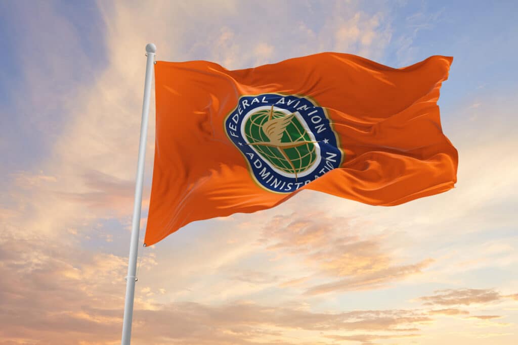 FAA flag against a sunset sky, representing the flying car prototype.