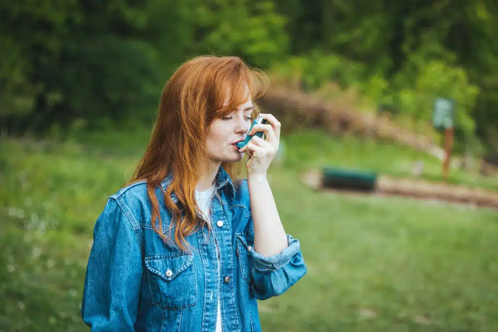 A woman using an inhaler, representing the albuterol recall.