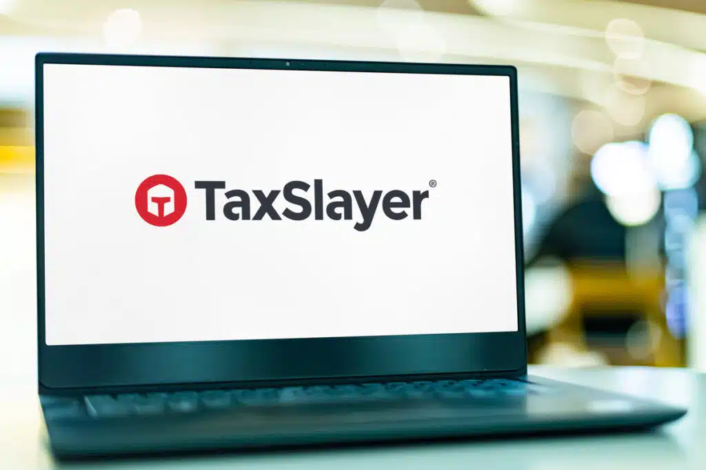 TaxSlayer logo displayed on a laptop screen, representing the TaxSlayer class action.